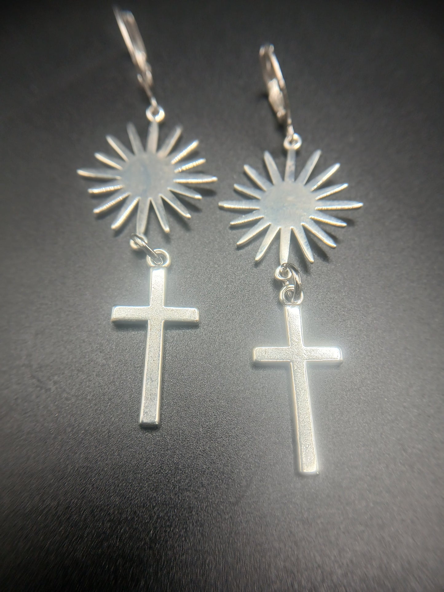 Silver sunburst and cross earrings